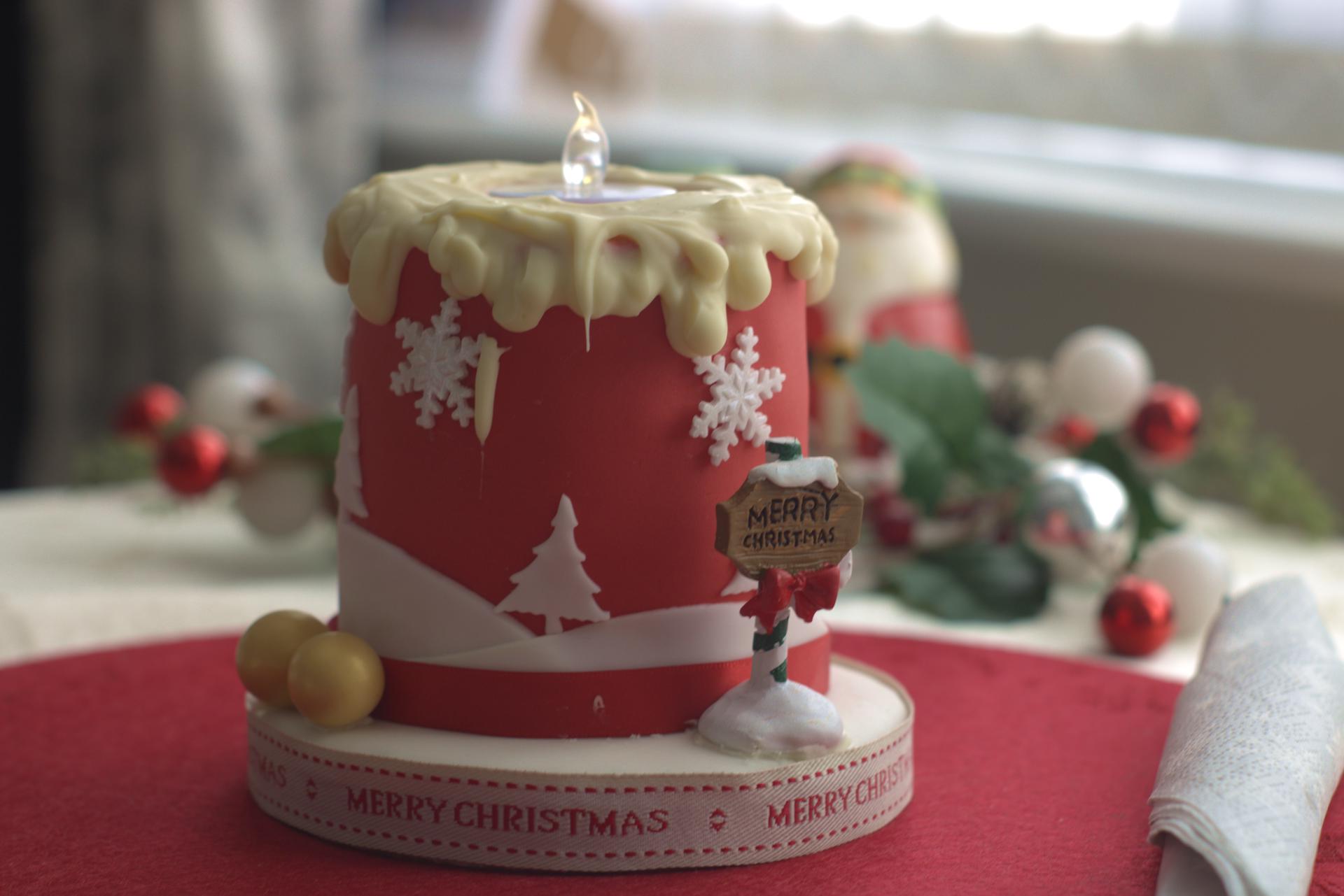 A candle cake with white cholocate topping